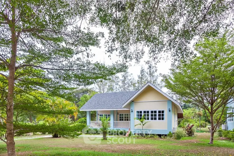 Charming countryside house with lush greenery and spacious front yard
