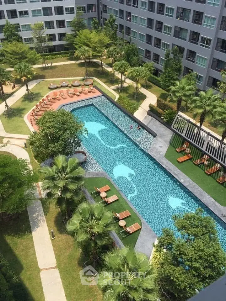 Luxurious condominium with stunning pool and lush garden view.