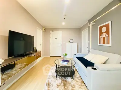 Modern living room with sleek furniture and large TV, perfect for relaxation.