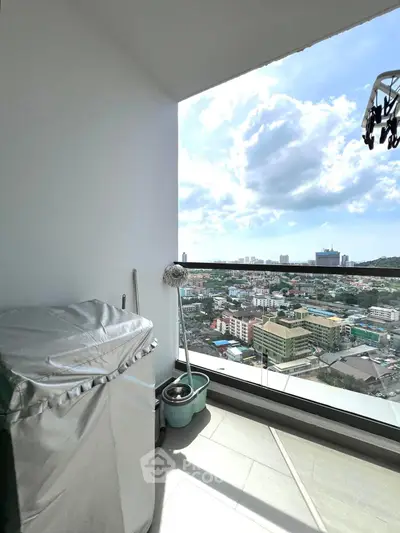 Stunning balcony view of cityscape with clear skies and modern railing.