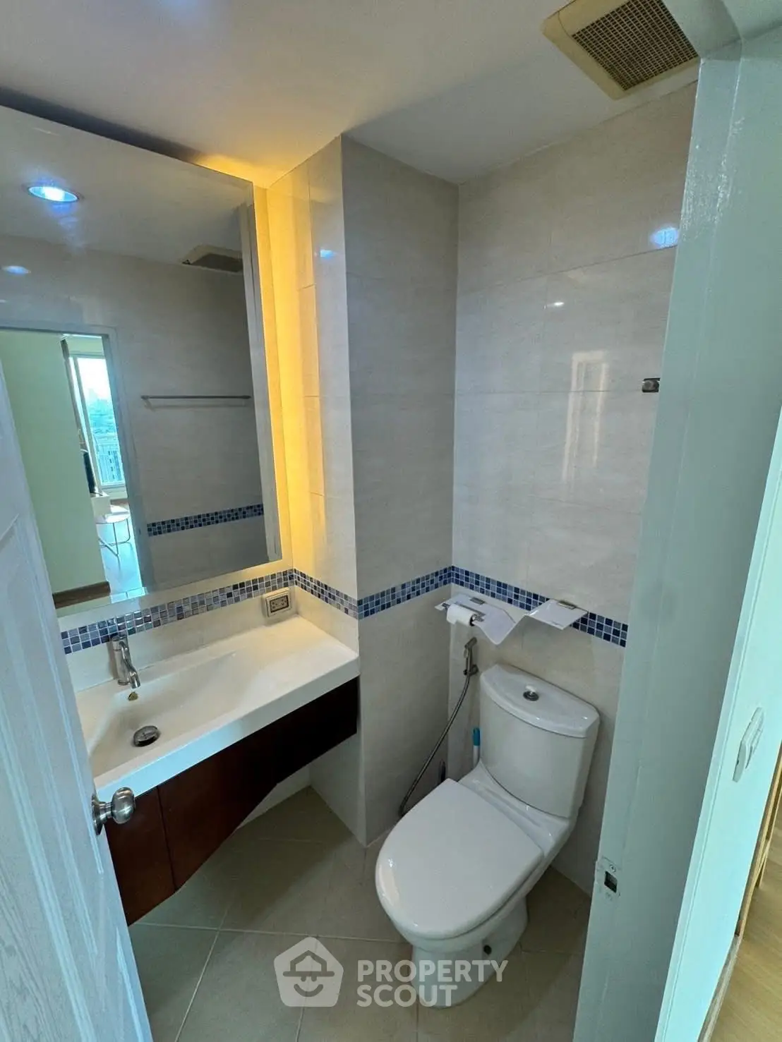 Modern bathroom with sleek fixtures and ambient lighting in a contemporary apartment.