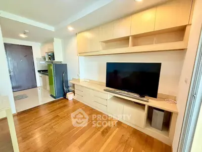 Modern living room with wooden flooring and built-in entertainment unit