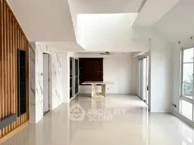 Spacious modern living room with marble accents and large windows