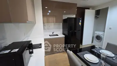 Modern kitchen with sleek appliances and dining area in stylish apartment