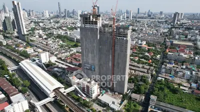 Aerial view of high-rise building under construction in bustling cityscape