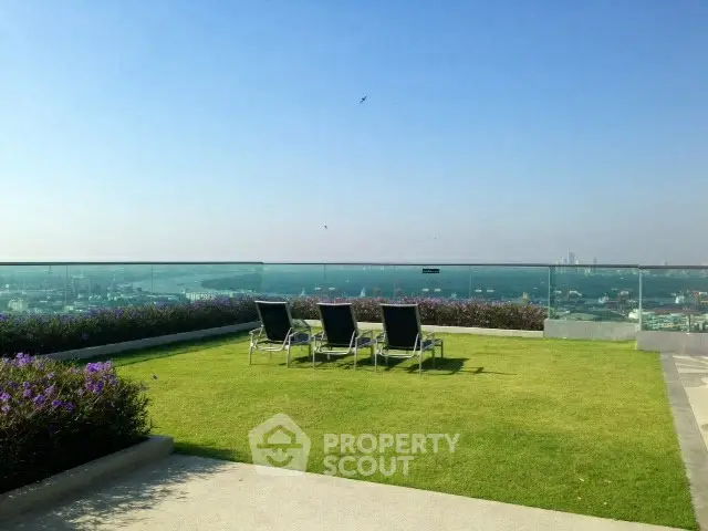 Luxurious rooftop garden with stunning city views and lounging chairs.