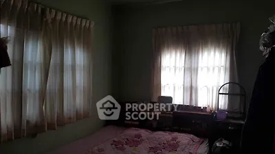 Cozy bedroom with soft lighting and floral bedding, perfect for relaxation.