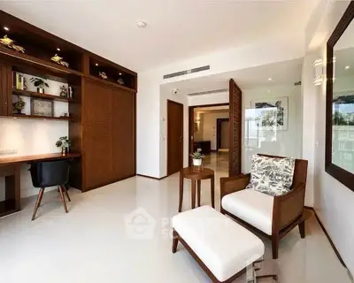 Spacious modern living room with elegant furniture and built-in study area, perfect for stylish urban living.