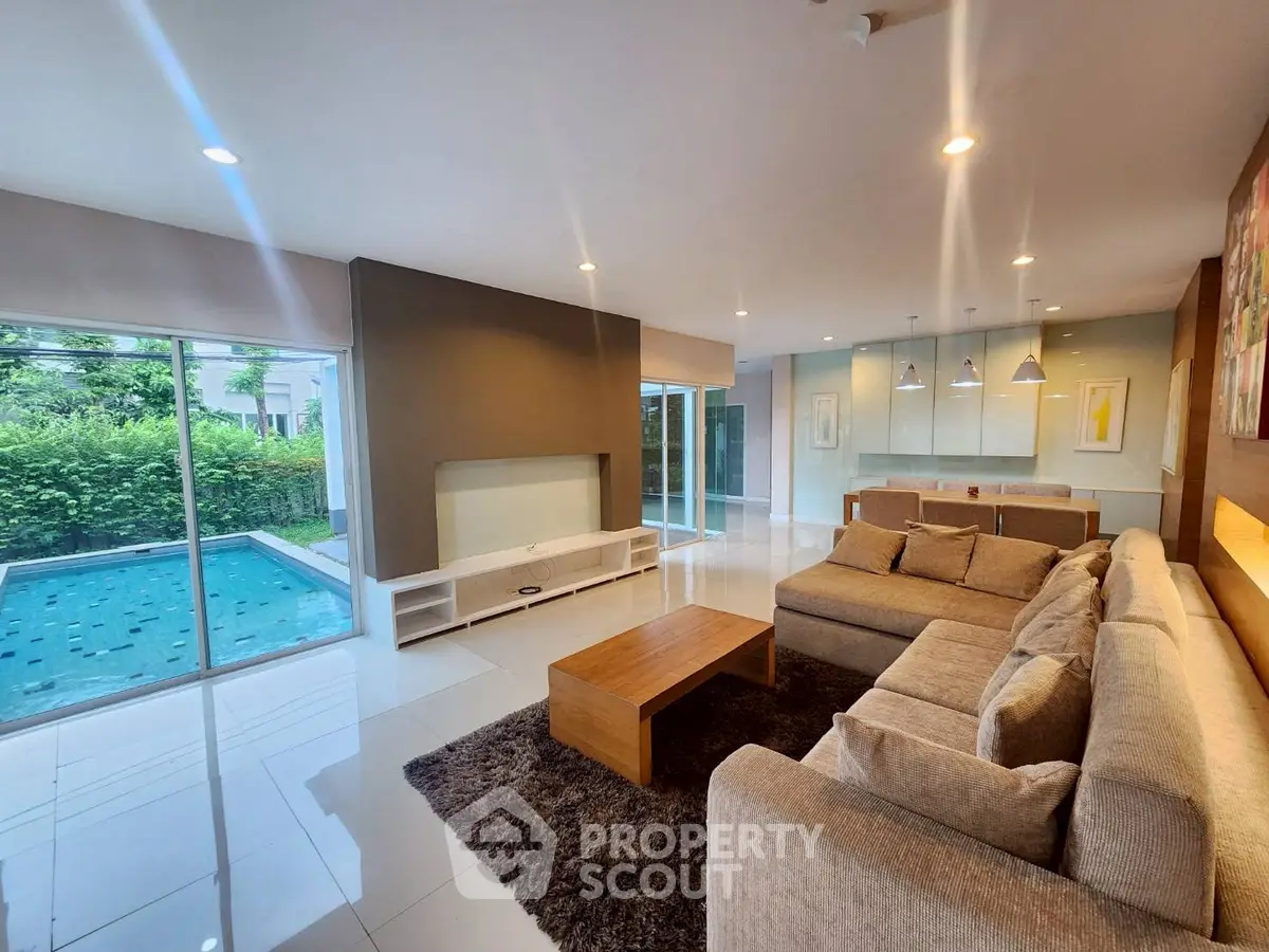 Spacious modern living room with pool view and elegant furnishings