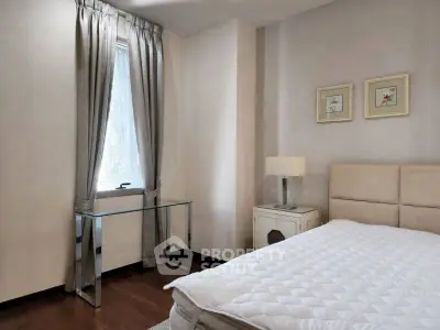 Cozy bedroom with elegant decor and natural light, featuring a comfortable bed and stylish furnishings.