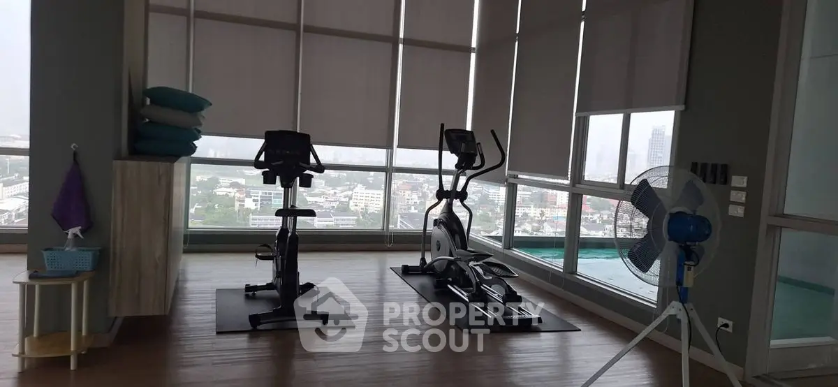 Spacious gym with modern equipment and panoramic city views