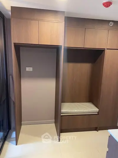 Modern built-in wooden storage unit in a stylish interior space