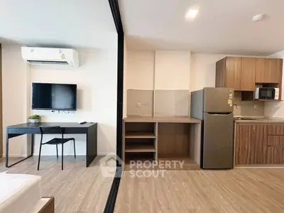 Modern studio apartment with open kitchen and sleek furnishings