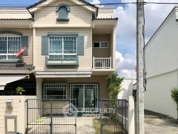 Charming two-story townhouse with gated entrance and balcony in a serene neighborhood.