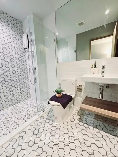 Modern bathroom with geometric tiles and glass shower enclosure