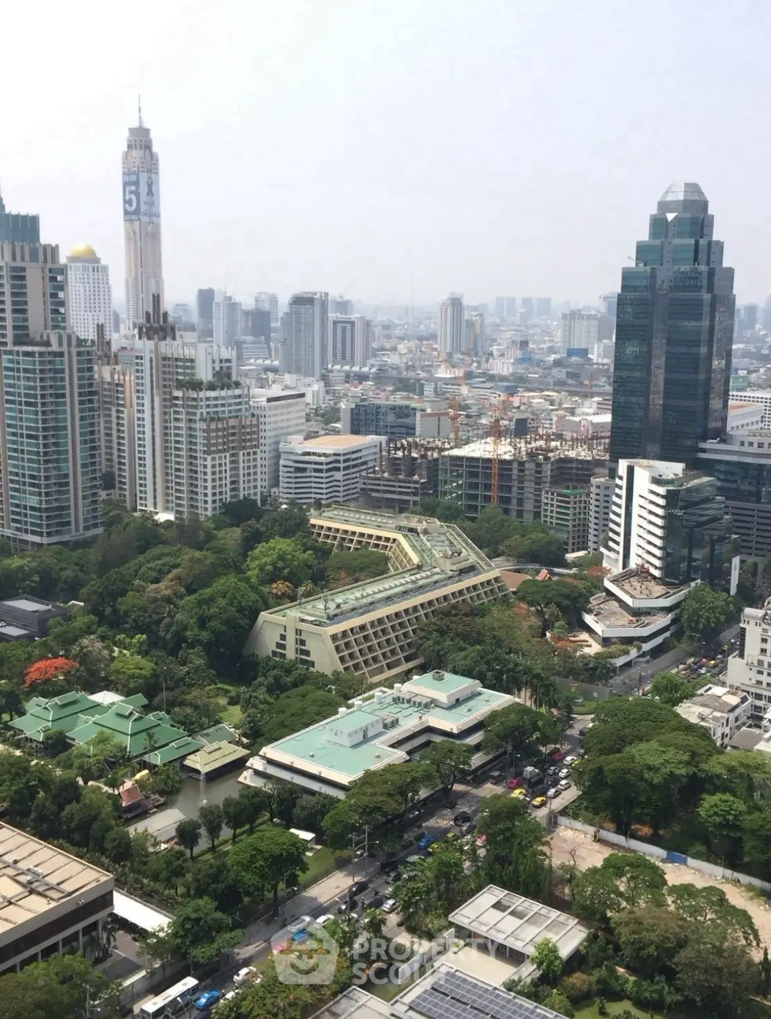 Stunning cityscape view showcasing modern skyscrapers and lush greenery in a vibrant urban setting.
