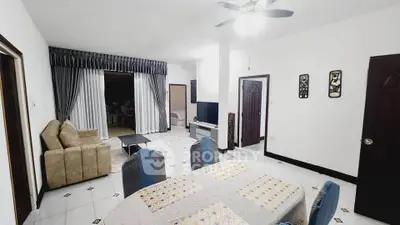 Spacious living room with modern decor and dining area