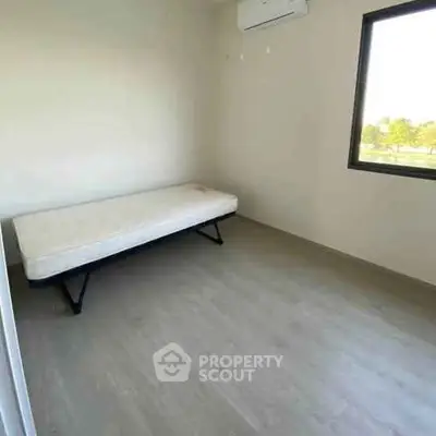 Minimalist bedroom with single bed and window view