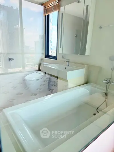 Luxurious bathroom with city view, featuring modern fixtures and a sleek bathtub.