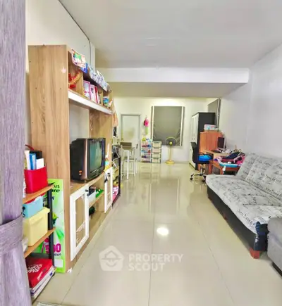 Spacious living room with modern furnishings and sleek tiled flooring, perfect for family gatherings.