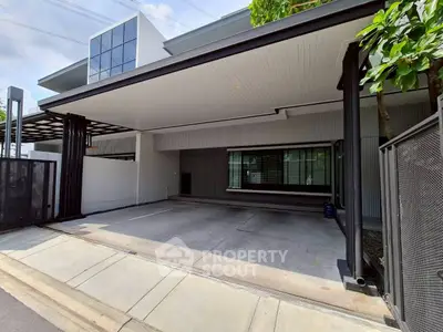 Modern residential building with spacious covered parking area and sleek design.