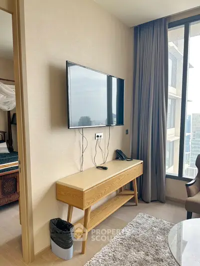 Modern living room with wall-mounted TV and large window view