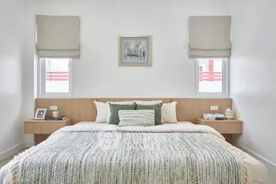 Elegant bedroom with modern decor and cozy bedding