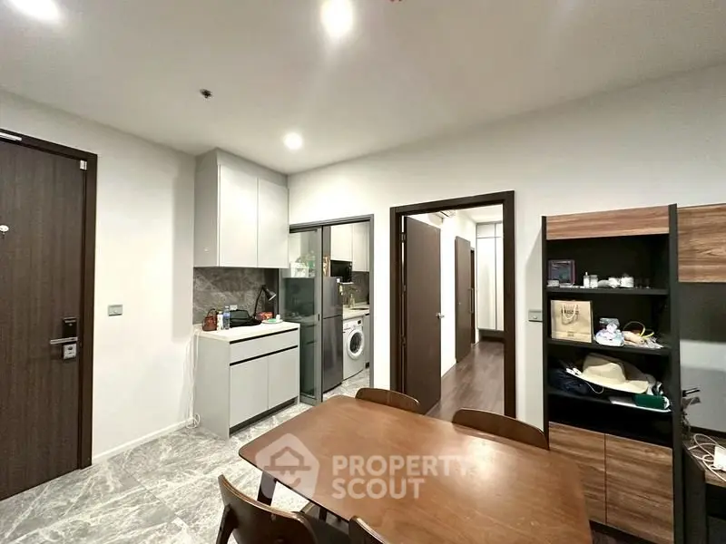 Modern kitchen with sleek cabinetry and integrated appliances in a stylish apartment.