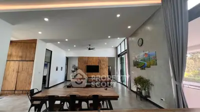 Spacious modern living room with stylish decor and large windows offering natural light.