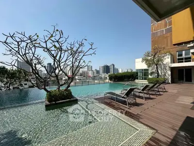 Luxurious rooftop pool with city skyline view and sun loungers, perfect for relaxation.