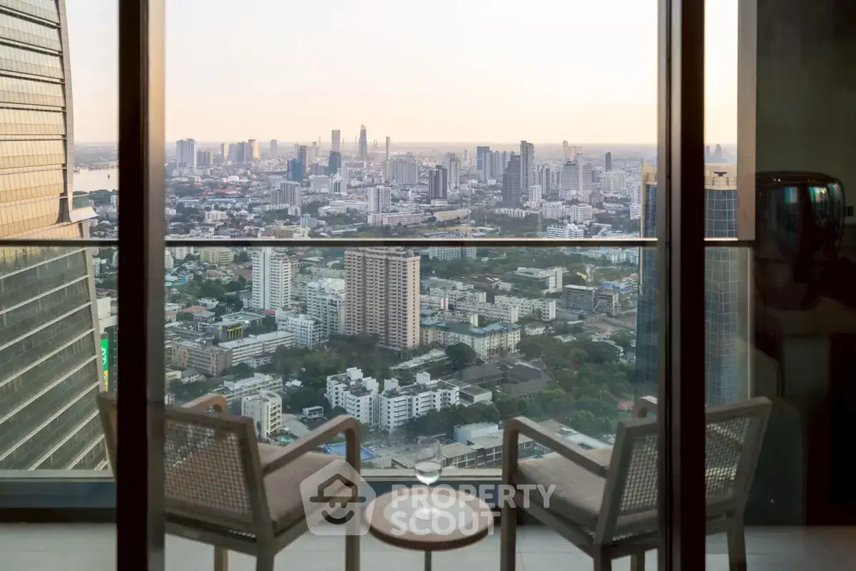 Stunning cityscape view from a high-rise balcony with elegant seating, perfect for urban living.