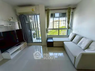 Modern living room with large TV and balcony view in stylish apartment