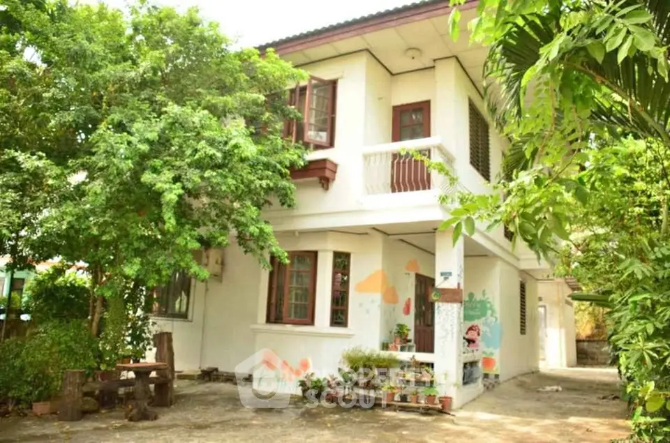 Charming two-story house with lush garden and unique exterior mural art