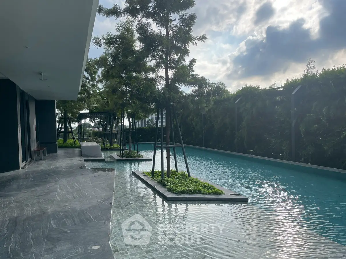 Luxurious residential pool area with lush greenery and serene ambiance