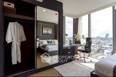 Luxurious bedroom with stunning city view and modern furnishings in high-rise apartment.