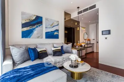 Luxurious modern living room with elegant decor and open layout, featuring plush seating and stylish artwork.