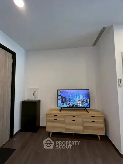Modern living room with sleek TV stand and cityscape on screen, perfect for urban living.