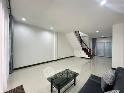 Spacious modern living room with sleek staircase and elegant decor