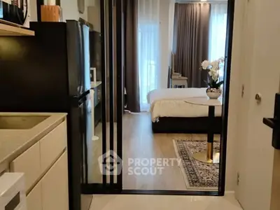 Modern studio apartment with open kitchen and cozy bedroom