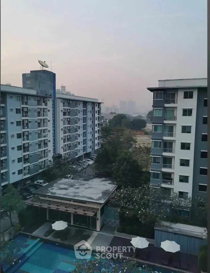 High-rise residential buildings with a swimming pool view in an urban setting.