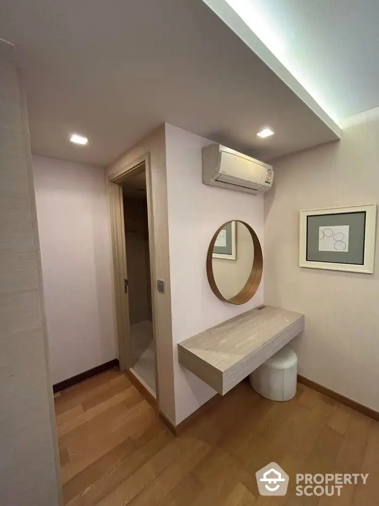 Modern minimalist hallway with wooden flooring and wall-mounted vanity