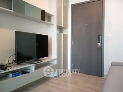 Modern living room with sleek TV setup and stylish door entrance