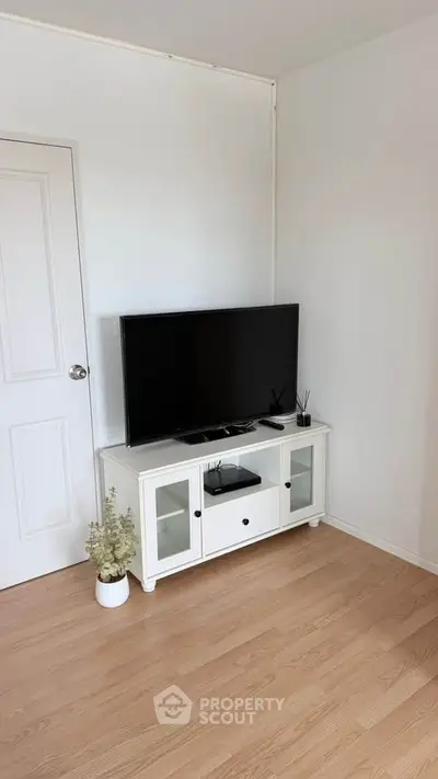 Modern living room with sleek TV stand and minimalist decor, perfect for cozy entertainment.