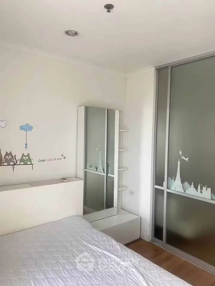 Charming bedroom with stylish decor and ample natural light, perfect for cozy living.
