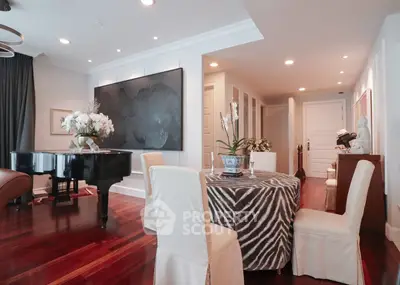 Luxurious living room with grand piano and elegant dining area, featuring hardwood floors and stylish decor.