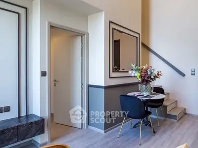 Modern interior with stylish dining area and staircase in a chic apartment.