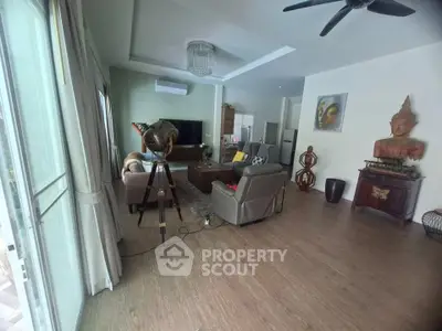 Spacious living room with modern decor and large windows for natural light.