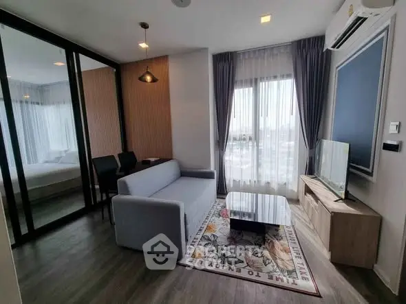 Modern living room with stylish decor and large windows offering natural light.
