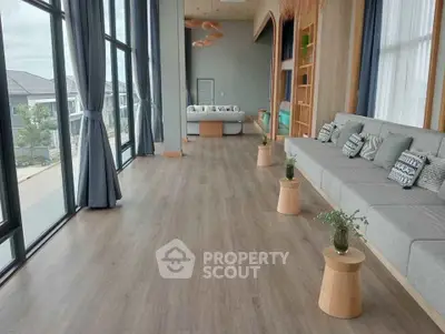 Spacious modern living room with large windows and stylish decor