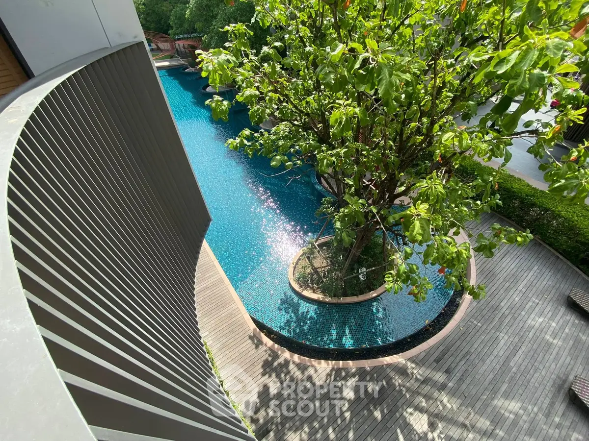 Stunning pool view with lush greenery and modern design elements.